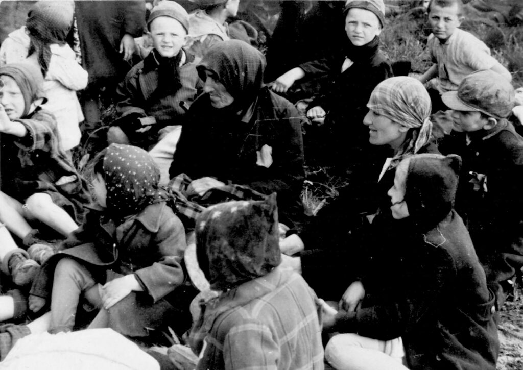Hungarian Jews waiting in the woods near the gas chambers at Auschwitz II-Birkenau. They have no idea that they are about to be gassed. Collection: Yad Vashem