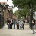 Tourists in front of the Arbeit-macht-frei-gate. Collection: Hans Citroen